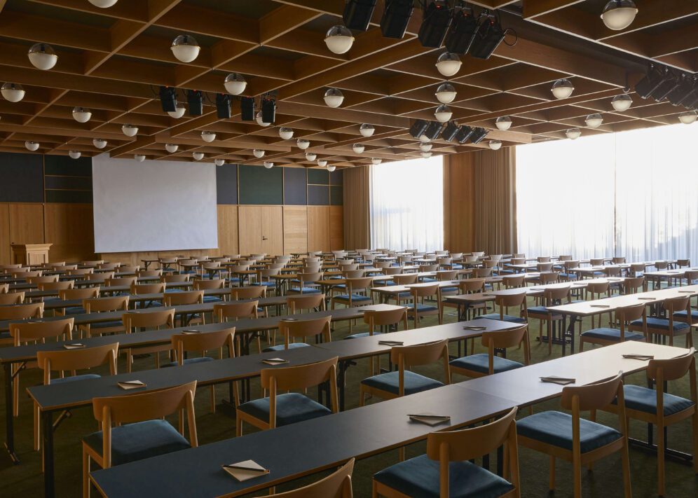 A room with floor to ceiling windows and multitudes of globe lights in the ceiling provide a large space with great lighting