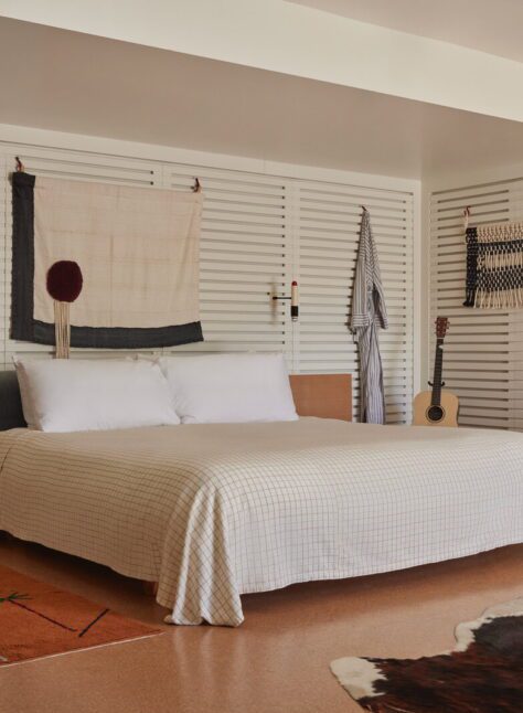 spacious king bed is adorned by wall-mounted night lights
