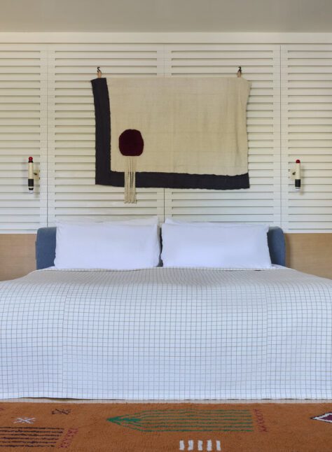 spacious king bed is adorned by wall-mounted night lights